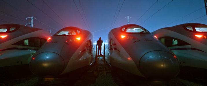 A worker stands among CRH Harmony bullet trains at a high-speed train maintenance base in Wuhan